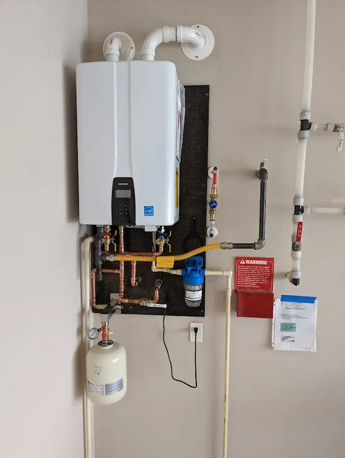 Professional plumber installing copper piping in a Middleton home